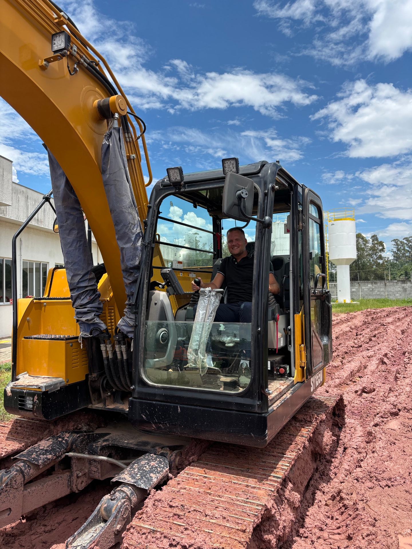 Tobias Schlitzke in an excavator at a Brazilian plant